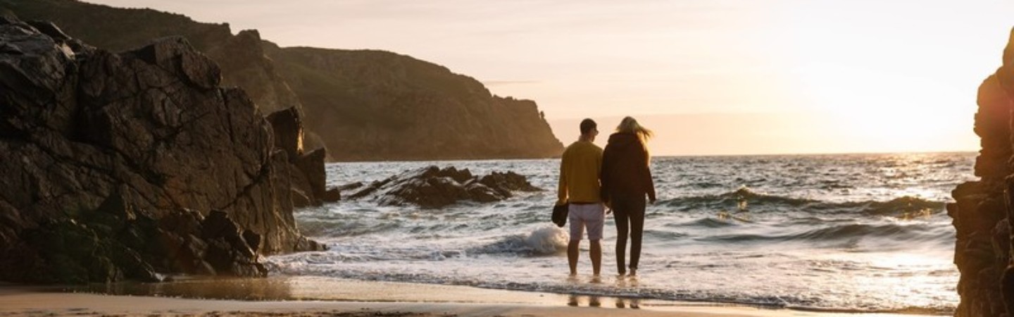 couple at the shores edge at sunset